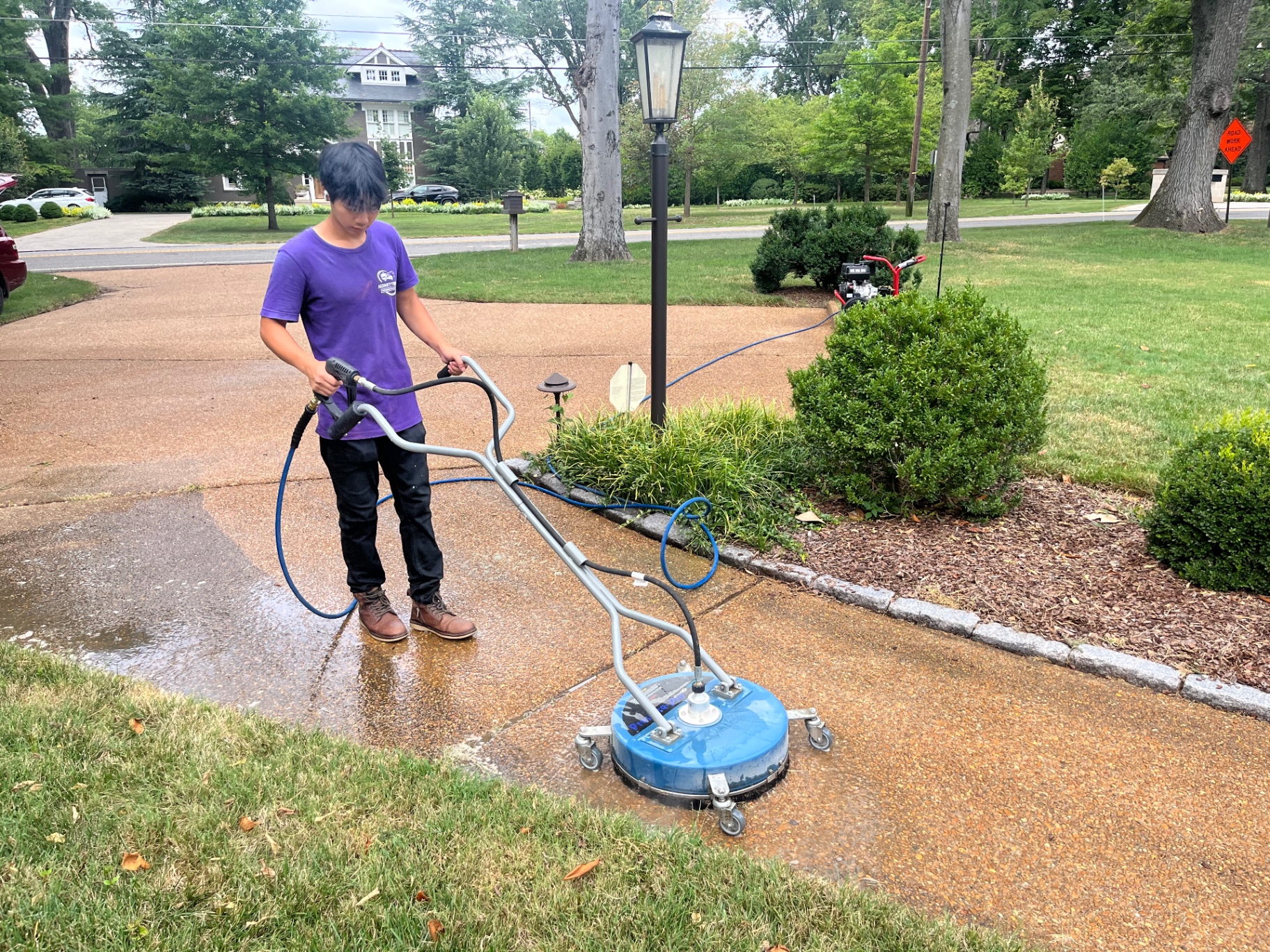 Jack from Honky Tonk Pressure Washing surface-cleaning a Nashville driveway